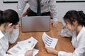 Depressed stressed young Asian business women suffering from severe problem between meeting in conference room.