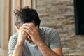 Depressed sulking man sitting alone at living room sofa and thinking Royalty Free Stock Photo