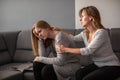 Depressed teen suffering from anxiety being taken care of by her mother Royalty Free Stock Photo