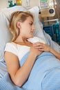 Depressed Teenage Female Patient Lying In Hospital Bed