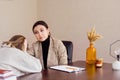 Depressed teenage girl with therapist. Teen crying during psychologist counseling about Bullying in school Royalty Free Stock Photo