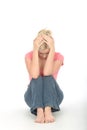 Depressed Thoughtful Unhappy Young Woman Sitting Alone on the Floor Royalty Free Stock Photo