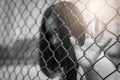 Depressed, trouble, help and chance. Hopeless women raise hand on chain-link fence ask for help Royalty Free Stock Photo