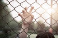 Depressed, trouble, help and chance. Hopeless women raise hand on chain-link fence ask for help Royalty Free Stock Photo