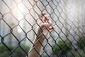 Depressed, trouble and solution. Women hand on chain-link fence.