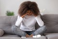 Depressed upset african american teen girl feeling hurt sitting alone Royalty Free Stock Photo