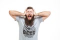 Depressed upset bearded man covered ears by hands and shouting Royalty Free Stock Photo