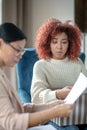 Depressed upset curly young woman having psychoanalysis Royalty Free Stock Photo