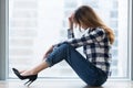 Depressed vulnerable young woman in trouble sitting on floor alone Royalty Free Stock Photo