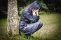 Depressed woman in focus near tree Royalty Free Stock Photo