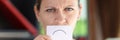 Depressed woman hides her mouth with white paper with sad sign. Royalty Free Stock Photo