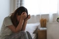 Depressed woman sitting on the bed had bad emotional feel lonely at home