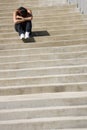 Depressed woman sitting on steps