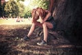 Depressed woman sittng under a tree Royalty Free Stock Photo