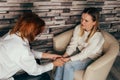 Depressed woman talking to psychotherapist at office. Royalty Free Stock Photo