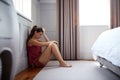 Depressed Woman Wearing Pajamas Sitting On Floor Of Bedroom Royalty Free Stock Photo