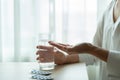 Depressed women hand hold medicine with a glass of water, healthcare and medicine recovery concept Royalty Free Stock Photo