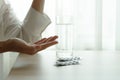 Depressed women hand hold medicine with a glass of water, healthcare and medicine recovery concept Royalty Free Stock Photo