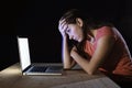 Depressed worker or student woman working with computer alone late night in stress Royalty Free Stock Photo