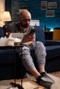 Depressed, worried man reading renter notification for unpaid bank bills news Royalty Free Stock Photo