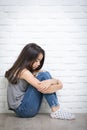 Depressed young asian girl sitting on floor at home Royalty Free Stock Photo