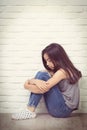 Depressed young asian girl sitting on floor at home Royalty Free Stock Photo