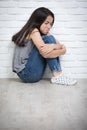 Depressed young asian girl sitting on floor at home Royalty Free Stock Photo