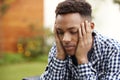 Depressed young African American  man with head in hands, close up, head and shoulders Royalty Free Stock Photo