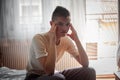 Depressed young boy is sitting in bed Royalty Free Stock Photo