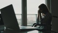 Depressed young disabled woman near the window having a headache Royalty Free Stock Photo