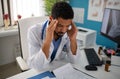 Depressed young male doctor with headache sitting in his office Royalty Free Stock Photo