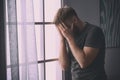 Depressed young man near window Royalty Free Stock Photo