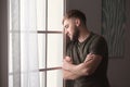 Depressed young man near window Royalty Free Stock Photo