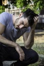 Depressed young man scratching his head, looking up Royalty Free Stock Photo