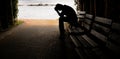 Depressed young man sitting on the bench