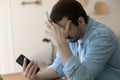 Unhappy man distressed with problems paying online on cell
