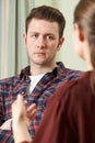 Depressed Young Man Talking To Counsellor Royalty Free Stock Photo