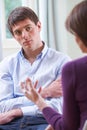 Depressed Young Man Talking To Counsellor Royalty Free Stock Photo