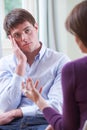 Depressed Young Man Talking To Counsellor Royalty Free Stock Photo