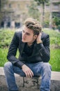 Depressed Young White Man Sitting at Street Side