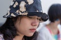 Depressed young woman bends down head sitting with blurred friend beside. Royalty Free Stock Photo