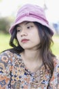 Depressed young woman bends down head sitting in the park. Outdoor portrait of a sad teenage girl looking thoughtful about Royalty Free Stock Photo