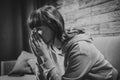 Depressed young woman crying alone at home, touching her face, stress and mental health concept. Black and white photo Royalty Free Stock Photo