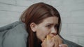 Depressed Young Woman Eats Burger Comforting Herself Sitting In Bedroom