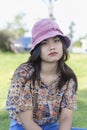 Depressed young woman looking at camera sitting in the park. Outdoor portrait of a sad teenage girl looking thoughtful about Royalty Free Stock Photo