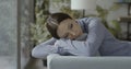 Depressed young woman lying on the couch Royalty Free Stock Photo