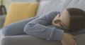 Depressed young woman lying down on the couch Royalty Free Stock Photo