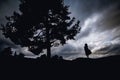 Depressed young woman sitting under the tree