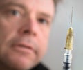 Drug Addict Staring at a Needle in narrow focus