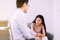 Depression asian woman sitting on sofa with psychologist at hospital,Female under a lot of pressure,World mental health day,Suicid Royalty Free Stock Photo